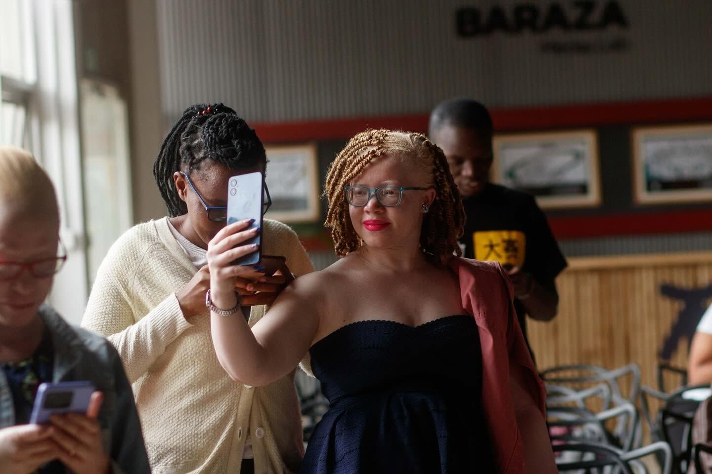A member of the community being photographed, with her consent, for the image library.